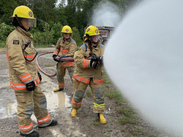 Rural on call firefighters spraying water